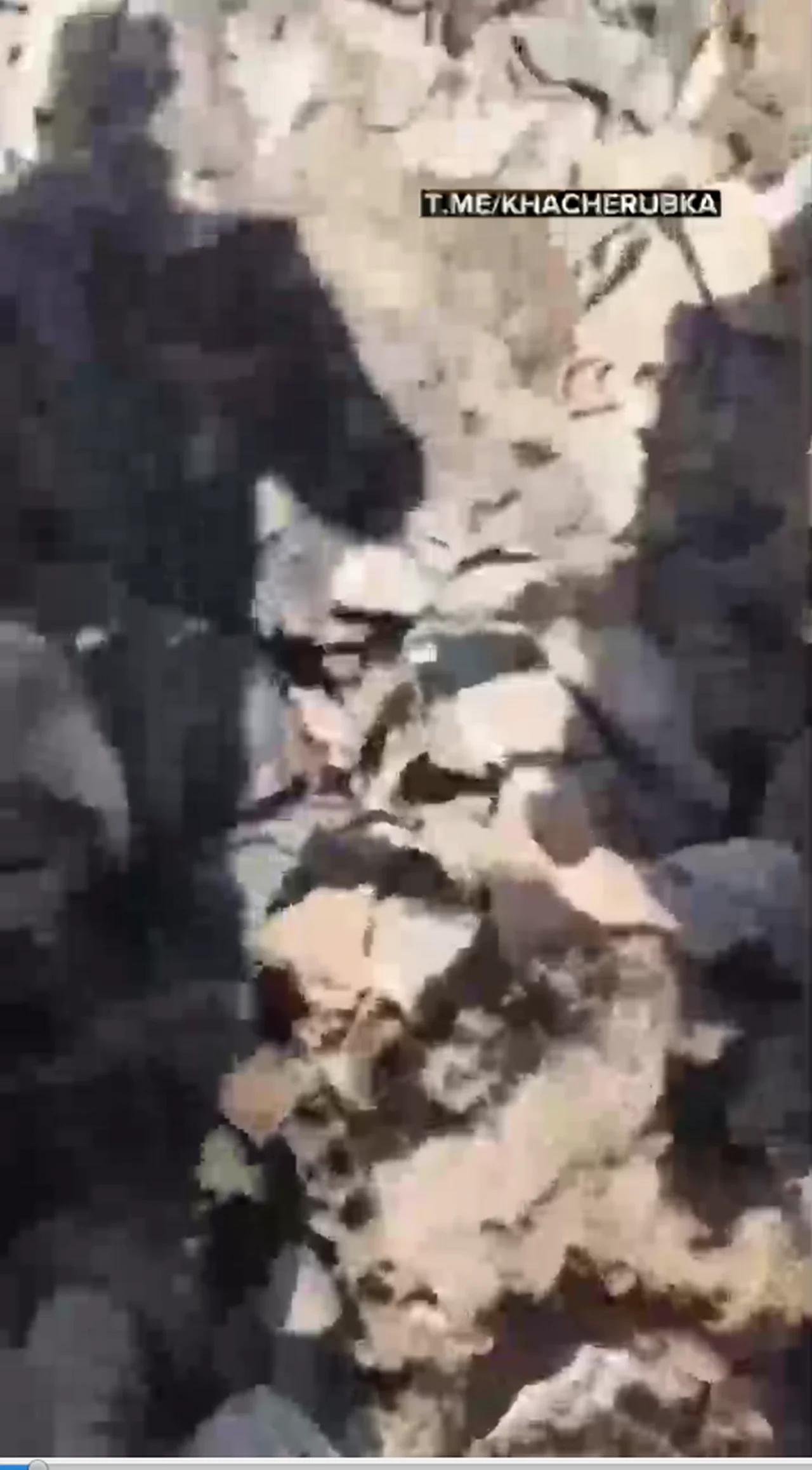 WARNING GRUESOME. Azeri soldiers stand over dead Armenian soldiers who