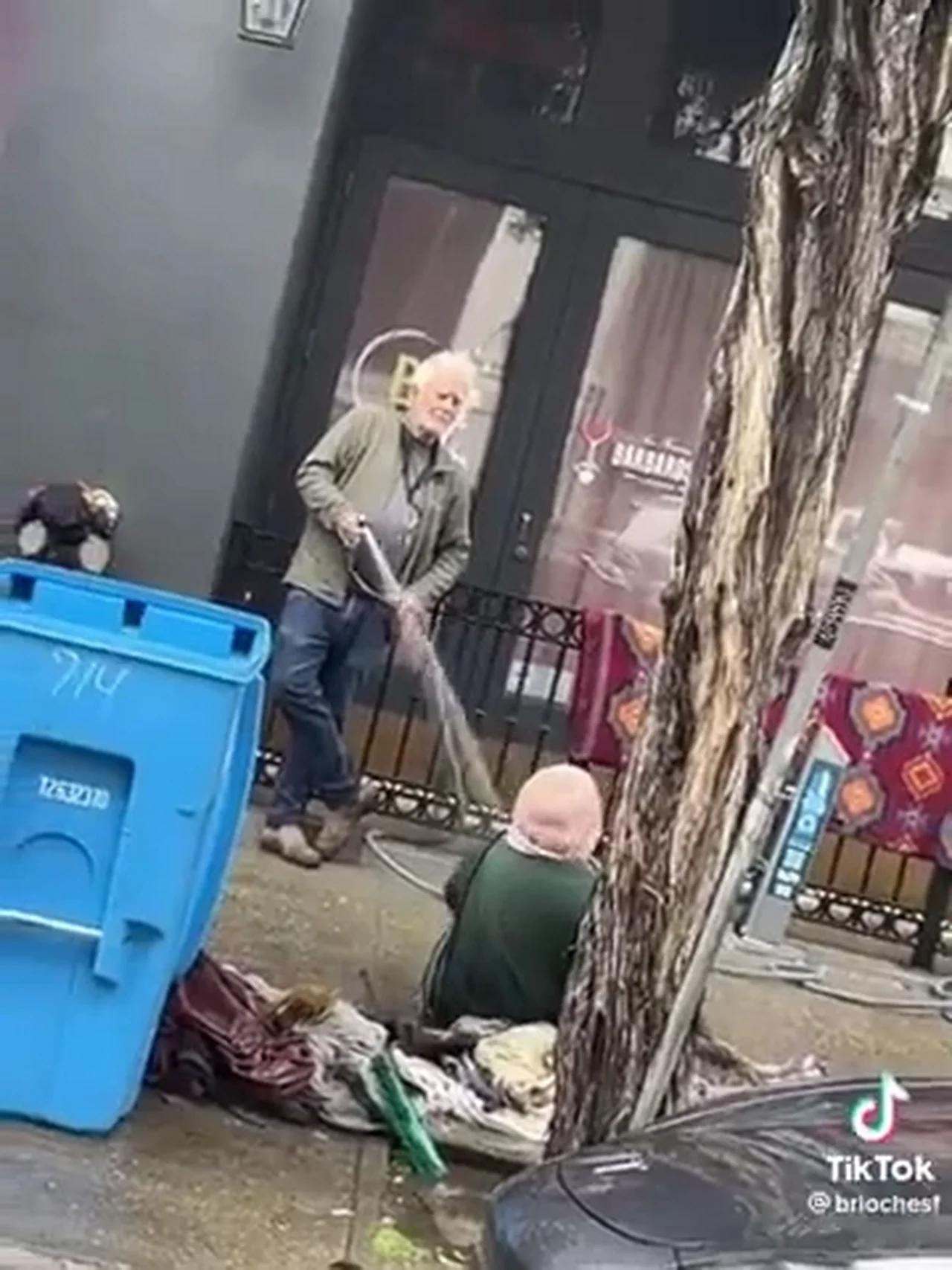 San Francisco Art Gallery owner hosing down a homeless woman